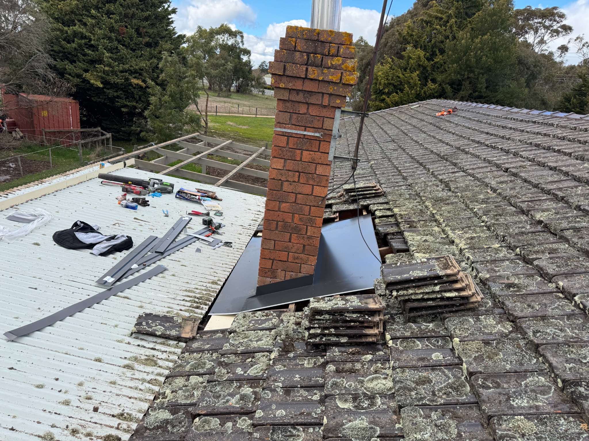 Chimney flashing rebuild — apron & soakers, lead‑free with proper backtray.