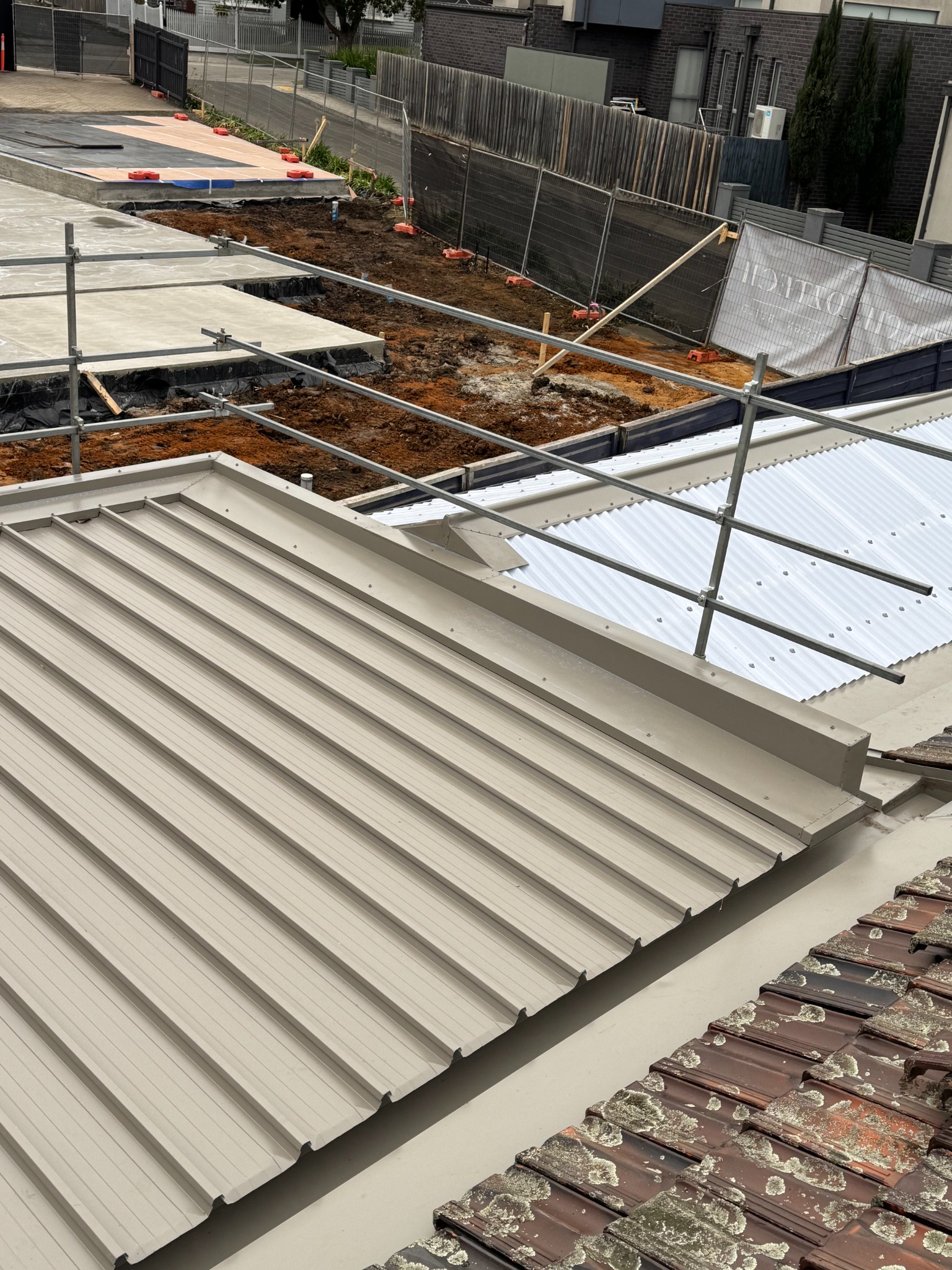 Finished re‑roof — straight seams, compliant penetrations, clean ridges.